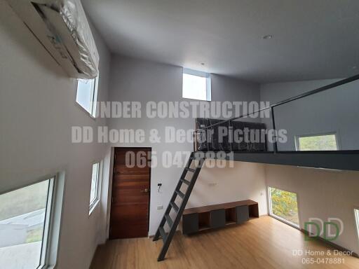 Spacious under construction living area with high ceiling and mezzanine