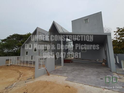 Contemporary house under construction with visible structural details and exterior design