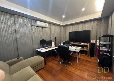 Spacious home office with desks, chairs, and monitors