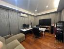 Spacious home office with desks, chairs, and monitors