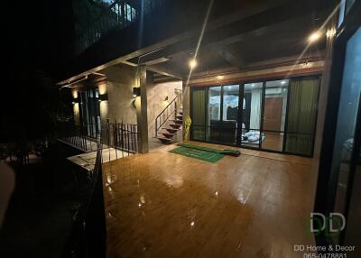 Spacious outdoor deck with glass doors leading inside