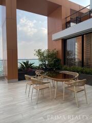 Spacious balcony with stylish outdoor furniture and waterfront view