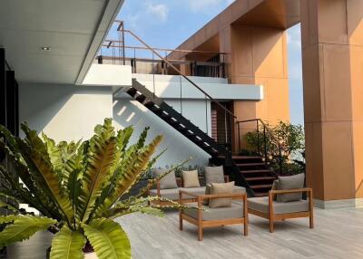 Modern outdoor terrace with seating area and staircase