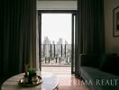 Elegant living room with city view through large balcony doors