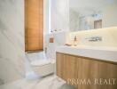 Modern bathroom with marble tiles and wooden vanity