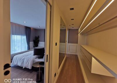 Modern bedroom with stylish lighting and ample storage