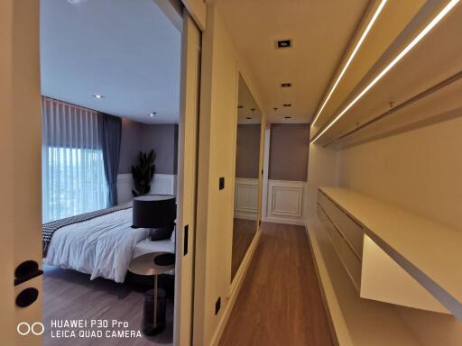 Modern bedroom with stylish lighting and ample storage