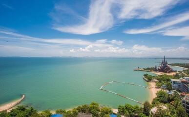 Aerial view from a high-rise apartment showing a coastal seascape with a clear view of the sea, surrounding buildings, and a famous landmark