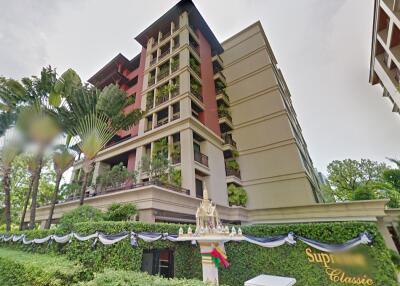 Exterior view of a modern residential building surrounded by lush greenery