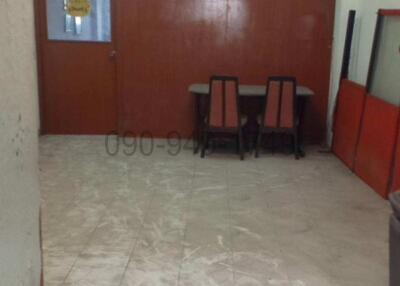 Spacious and brightly lit empty room with tiled floor and red walls