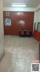 Spacious and brightly lit empty room with tiled floor and red walls