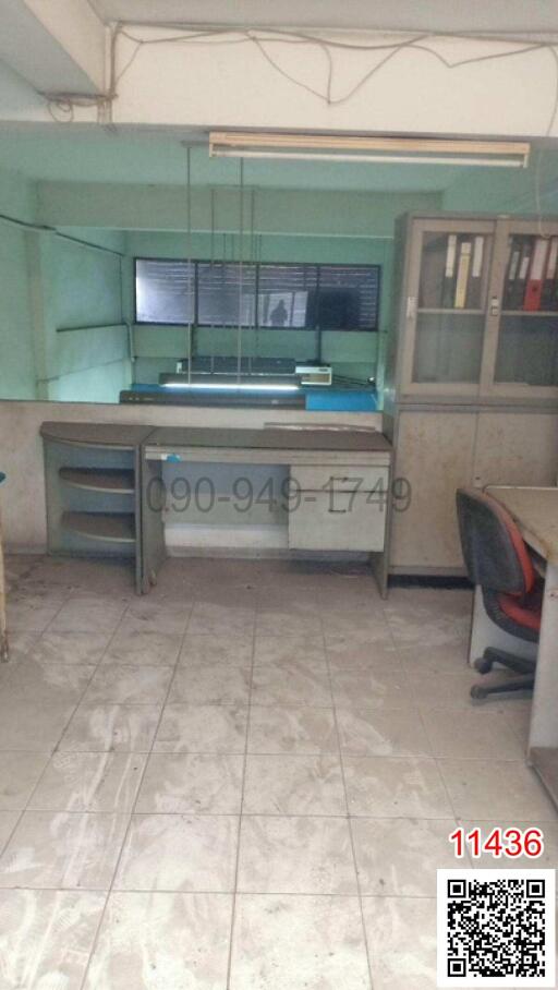 Spacious office space with large desk and tiled flooring