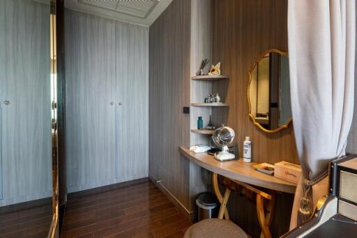 Elegant bedroom with a stylish grooming corner featuring desk and mirror
