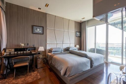 Modern bedroom with large windows and elegant furnishings
