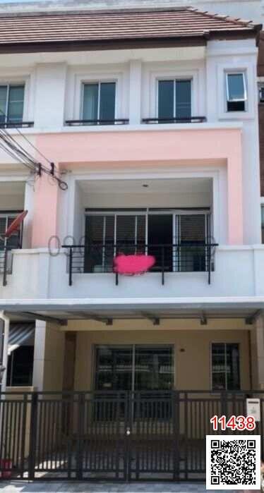 exterior view of a modern residential townhouse with balcony and protective railing