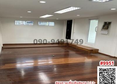 Spacious living room with wooden flooring and ample natural light