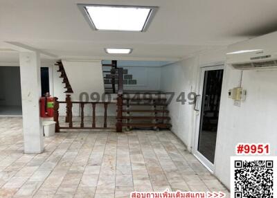 Spacious living room with staircase and tiled flooring