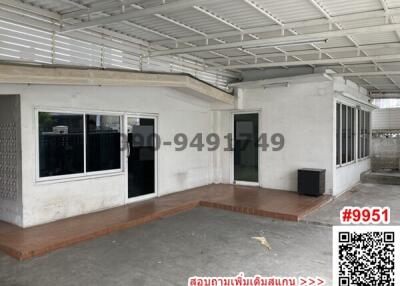 Spacious covered patio area with adjacent buildings