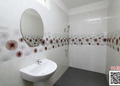 Modern bathroom with decorative tiles and white fixtures