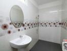 Modern bathroom with decorative tiles and white fixtures