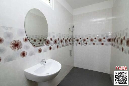 Modern bathroom with decorative tiles and white fixtures