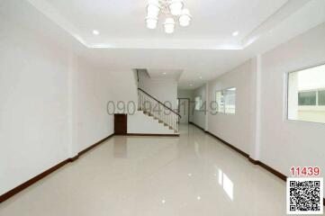 Spacious and well-lit living room with staircase