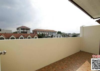 Spacious balcony with scenic suburban view and patterned tiling