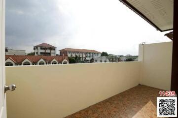 Spacious balcony with scenic suburban view and patterned tiling