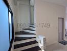 Modern staircase in a residential house with large window and neutral color scheme