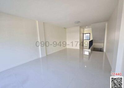 Spacious and bright empty living room with glossy tiled floor