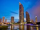 Modern skyscraper along the riverfront at dusk