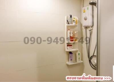 Compact bathroom with wall-mounted water heater and white tiles