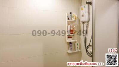 Compact bathroom with wall-mounted water heater and white tiles