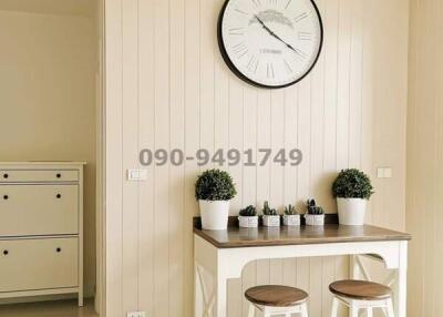 Elegant minimalist design in a bright living space with decorative wall and classic clock