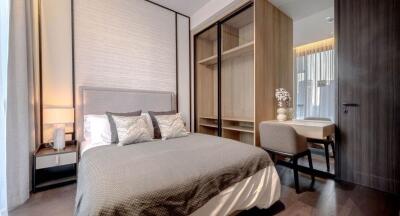 Elegant modern bedroom with integrated wardrobe and seating area