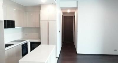 Modern kitchen with white cabinetry and built-in appliances