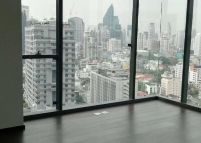 Spacious living room with large windows showcasing cityscape views