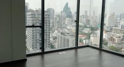 Spacious living room with large windows showcasing cityscape views