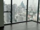 Spacious living room with large windows showcasing cityscape views