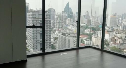 Spacious living room with large windows showcasing cityscape views