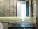 Modern bathroom with marble countertops and mirrored cabinets