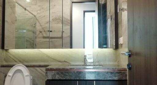 Modern bathroom with marble countertops and mirrored cabinets