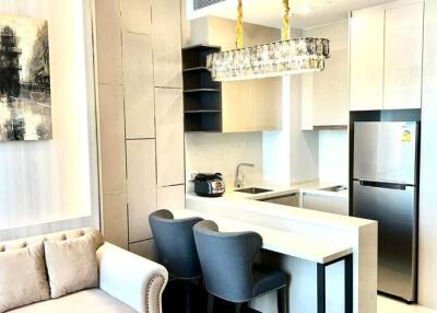 Modern kitchen with integrated living space featuring stylish furniture and appliances