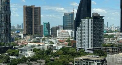 Wide view of a bustling cityscape with high-rise buildings and clear skies