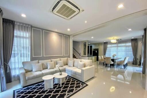 Spacious and modern living room with sectional sofa and dining area