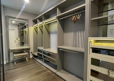 Spacious modern walk-in closet with custom shelving and integrated lighting