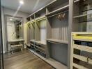 Spacious modern walk-in closet with custom shelving and integrated lighting