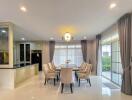 Elegant dining room with open concept kitchen and modern lighting