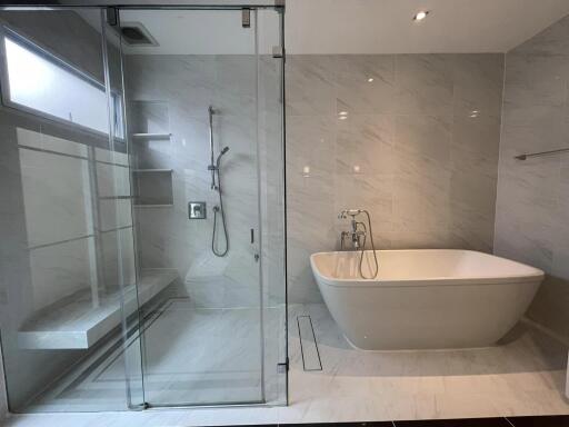 Modern bathroom with freestanding bathtub and glass shower