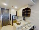 Modern compact kitchen with integrated appliances and dining setup